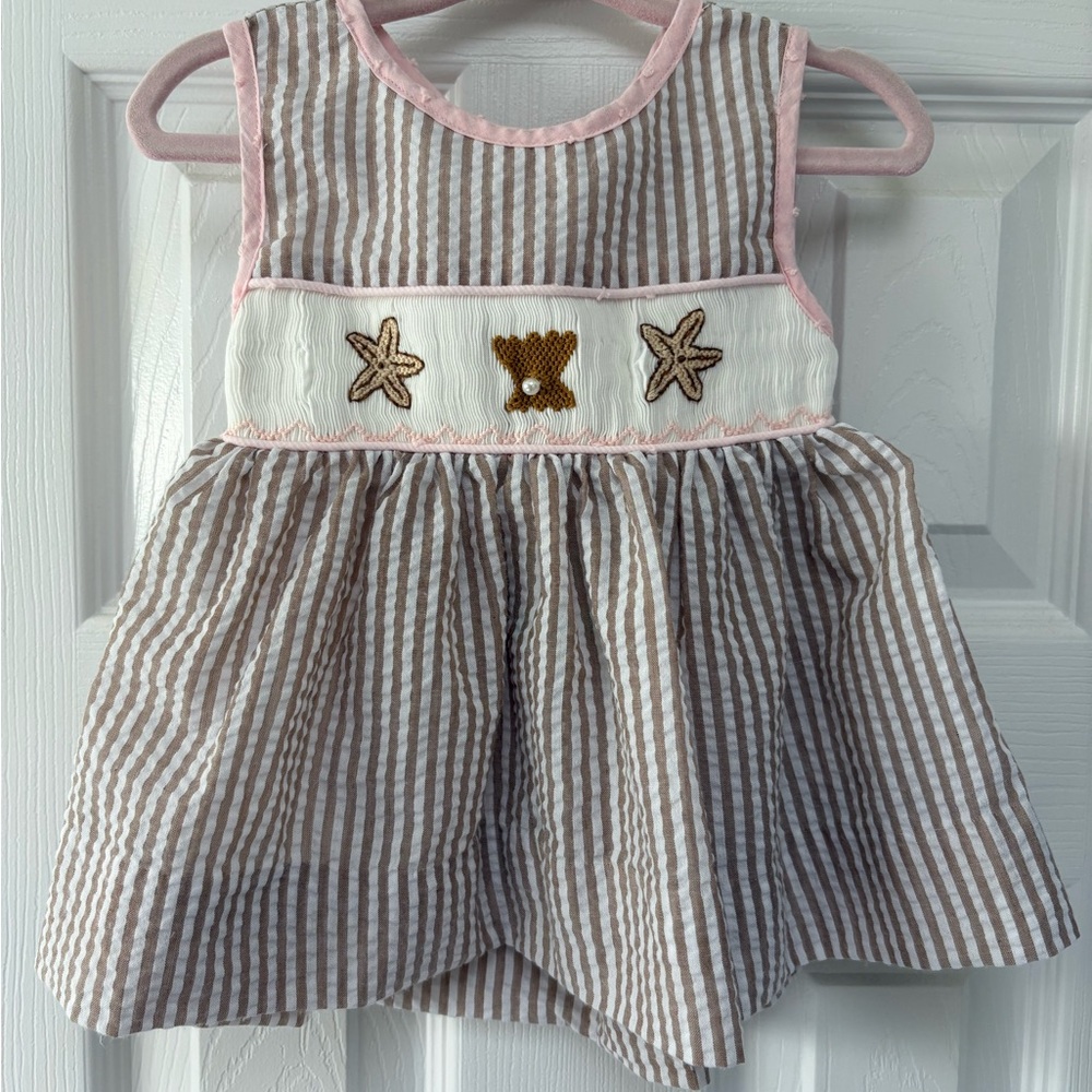The Smocked Flamingo Striped Baby Dress with Shell & Starfish Embroidery